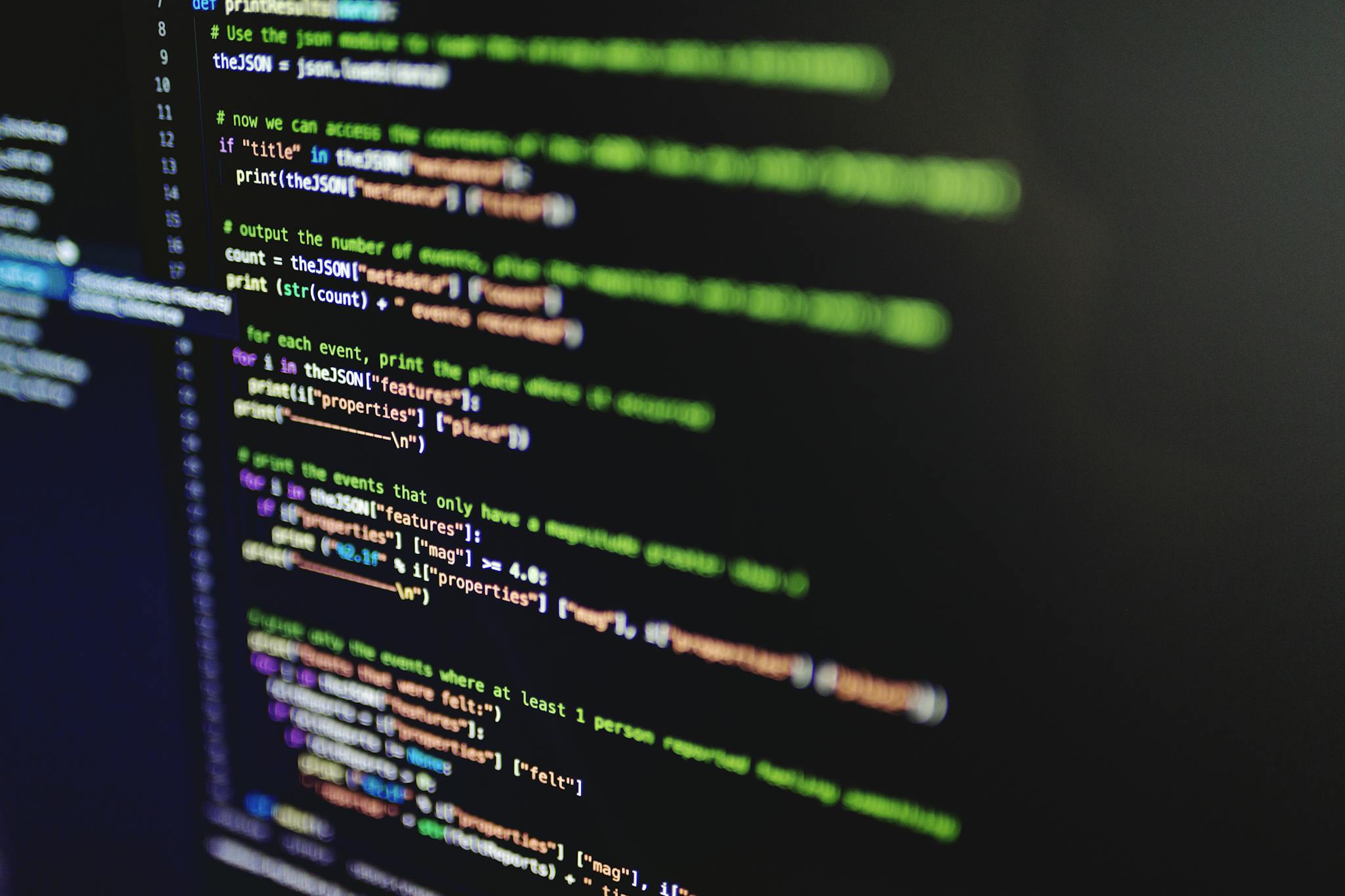 High-resolution image of colorful programming code highlighted on a computer screen.